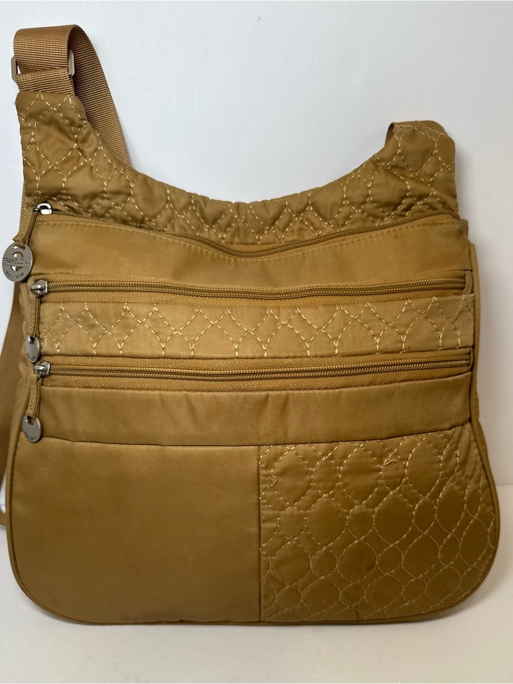 Travelon Anti-Theft Quilted Nylon Crossbody Bag in a mustard gold or dark khaki